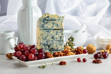 Gorgonzola cheese with walnuts, red grapes, and thyme.