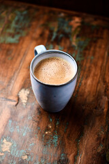 Pizza with salami, mozzarella cheese, black olives and pepper. Rustic wooden background. Soft focus. Copy space.	