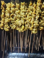 Chicken intestine satay is a popular Indonesian street food, skewered and grilled to perfection, offering a smoky, savory taste with a unique chewy texture