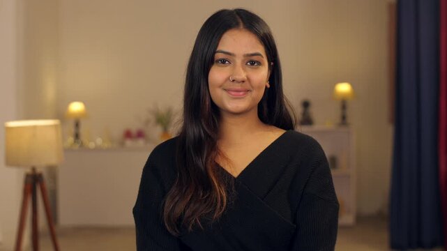 Closeup shot of a young beautiful lady giving a toothy smile - portrait shot  long hair  teenager. An Indian woman at home - smiling while looking at the camera   wheatish skin  Asian girl  college...