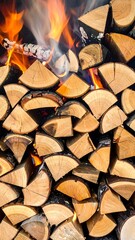 A close-up view of stacked firewood, flames and smoke