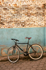 A bicycle parked against a wall along a street in Kigali, Rwanda.