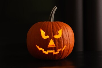 Scary jack o'lantern pumpkin in darkness. Halloween decor
