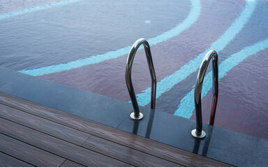 Grab bar ladder in swimming pool.