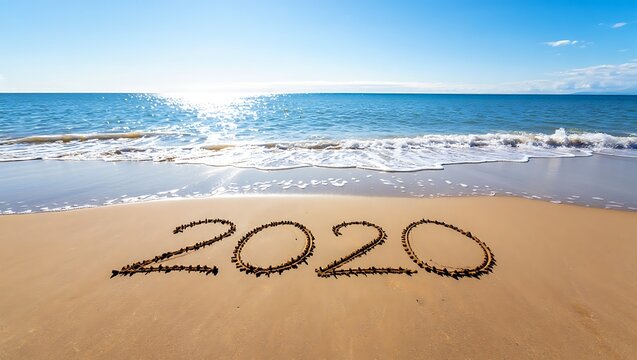Year 2020 written in sand on a beautiful beach scene
