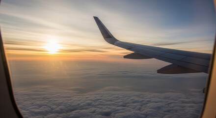 Fototapeta premium Airplane wing seen from window during sunrise over clouds, travel concept