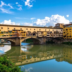 Obraz premium A scenic view of an old stone bridge over a calm river, with buildings lining the banks