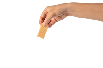 Wafer biscuit with chocolate cream and hand isolated on transparent background