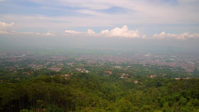 The view of Bandung City from the peak of Batu Kuda Hill on Mount Manglayang.