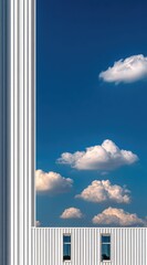 White building, pillar, and clouds against a vibrant blue sky