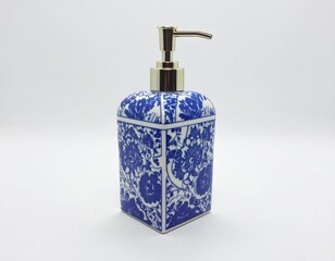 Obraz premium Elegant blue and white patterned soap dispenser with gold pump
