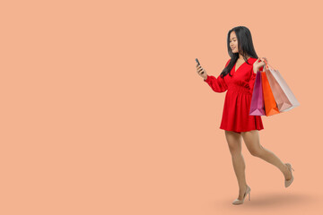 Young woman enjoys online shopping while carrying shopping bags