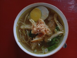 a bowl of chicken soto