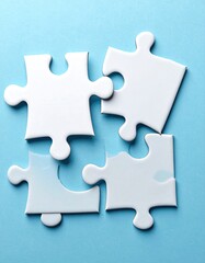 Four white puzzle pieces on light-blue background