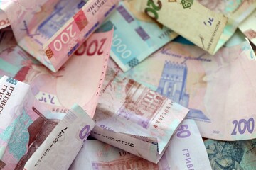 Big amount of different Ukrainian hryvnia money bills. Pile of crumpled ukrainian banknotes