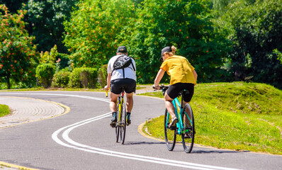 Cyclists ride on the bike path in the city Park
