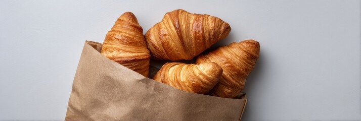 Golden croissants peek from rustic paper bag, evoking cozy Parisian mornings, perfect for Bastille Day or National Croissant Day