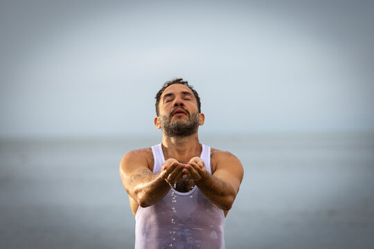 Man wearing white dancing in the beach on Cape Cod during the pi