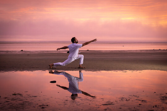 Man wearing white dancing in the beach on Cape Cod during the pi