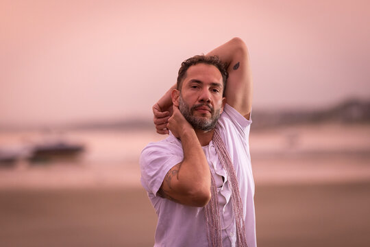 Man wearing white dancing in the beach on Cape Cod during the pi