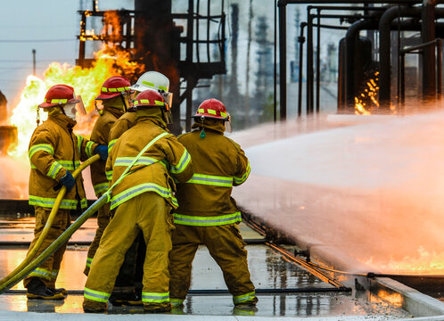 Firefighters practice in a refinery