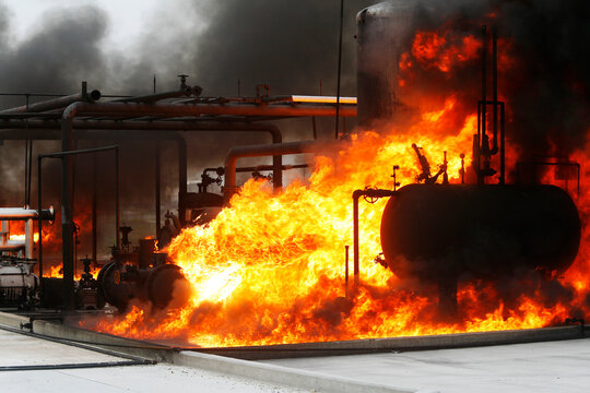 Firefighters practice in a refinery