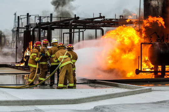 Firefighters practice in a refinery