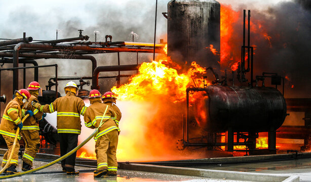 Firefighters practice in a refinery