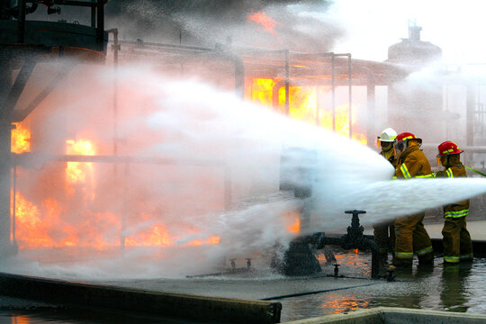 Firefighters practice in a refinery