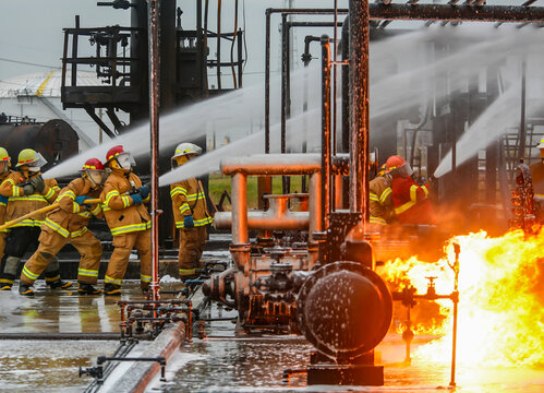 Firefighters practice in a refinery