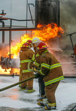 Firefighters practice in a refinery