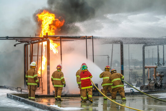 Firefighters practice in a refinery