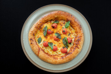 Delectable Pizza Temptation: A close-up shot reveals a freshly baked pizza, with bubbly cheese, vibrant tomatoes, and fragrant basil leaves, all nestled on a rustic plate. A culinary masterpiece.