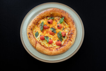 Delicious Pizza Delight: A close-up studio shot captures the appetizing allure of a fresh, Margherita-style pizza, with perfectly baked crust and vibrant, sun-ripened tomatoes. 