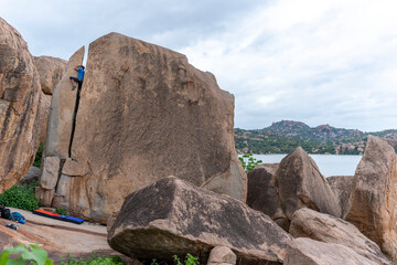 A rock climber climbing through the crack in Hampi.