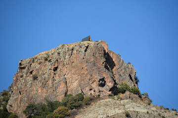 Wooden cottage on the mountain. House on the top of a cliff. Rocky Mountains and house. Mountain holidays
