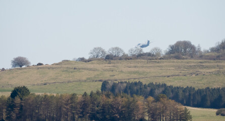 RAF Airbus C.1 A400M Atlas military transport aircraft in flight on a low-level cargo drop run, blue sky