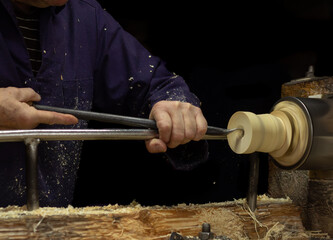 Woodworker in the workshop. Carpenter's hands making wooden details