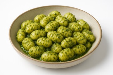 Bowl of gnocchi with pesto sauce, a traditional Italian dish.