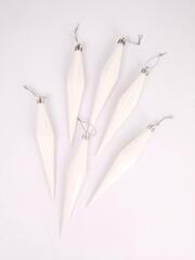 White icicles toys on the Christmas tree on a white background, Christmas and New Year concept