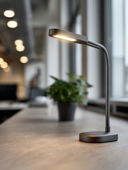 Fototapeta premium Modern desk lamp illuminating an office workspace.