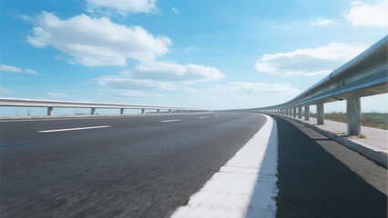 Smooth asphalt road under clear blue sky with guardrails