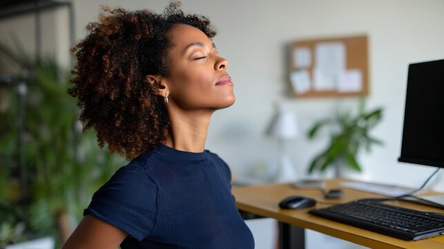Woman meditating at work desk