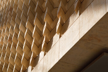 Modern Parliament Building Facade with Geometric Stone Panels and Shadows