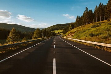 Scenic road through lush green hills under clear blue sky