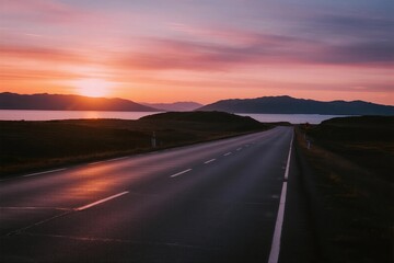 Naklejka premium Beautiful Sunset Over an Empty Road with Mountains in the Distance