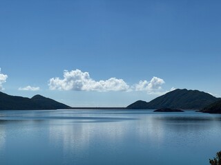 Serene lake landscape with distant mountains.