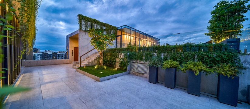 Modern Rooftop Terrace with Greenery and Stairs at Twilight