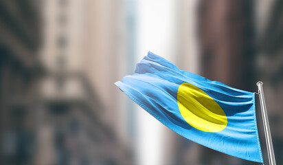 Palau national flag waving on street. A beautiful with mast with blur buildings. Palau national...