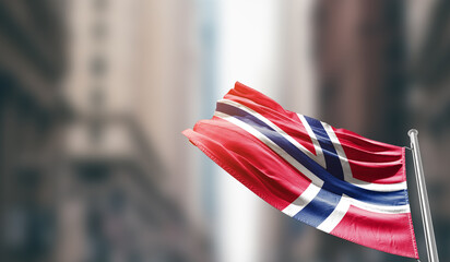 Norway national flag waving on street. A beautiful with mast with blur buildings. Norway national...